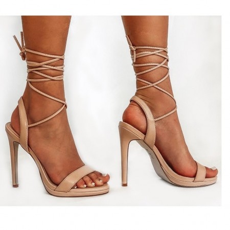 Beige sandal with ankle strap.